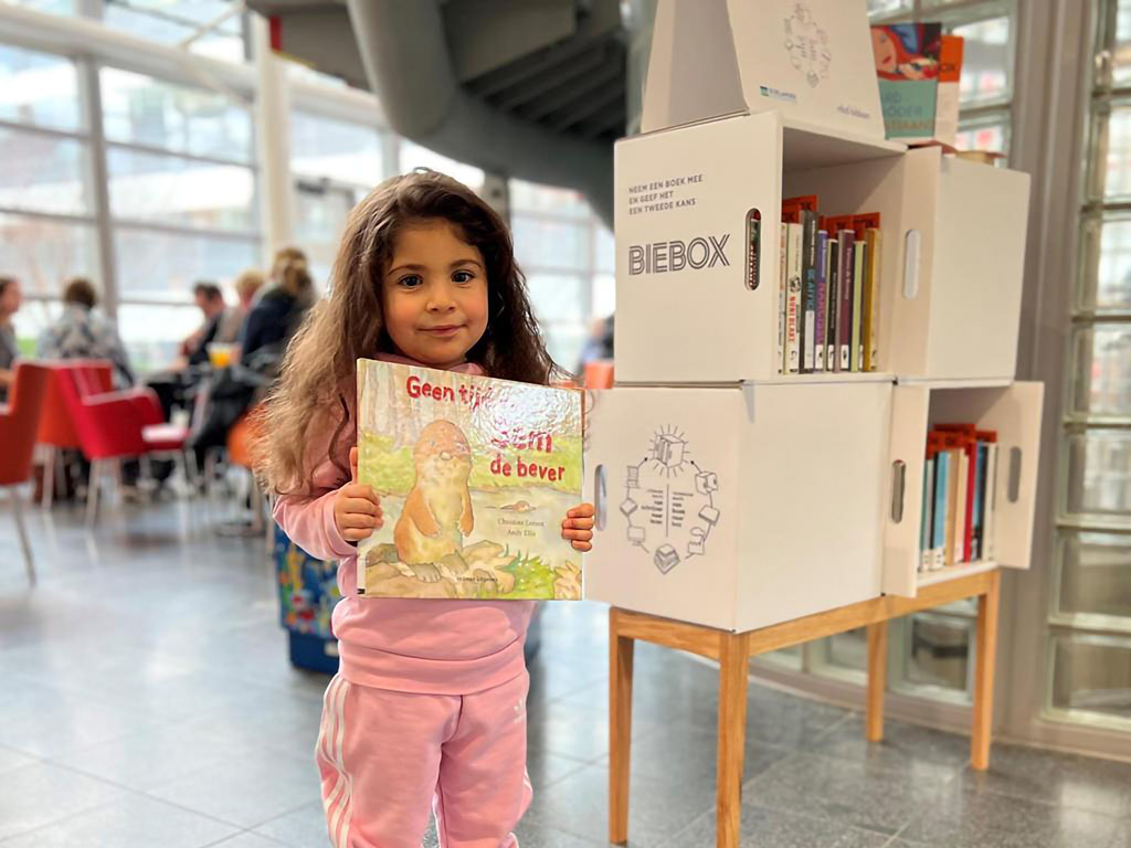 Biebox: meisje met hergebruikt bibliotheekboek